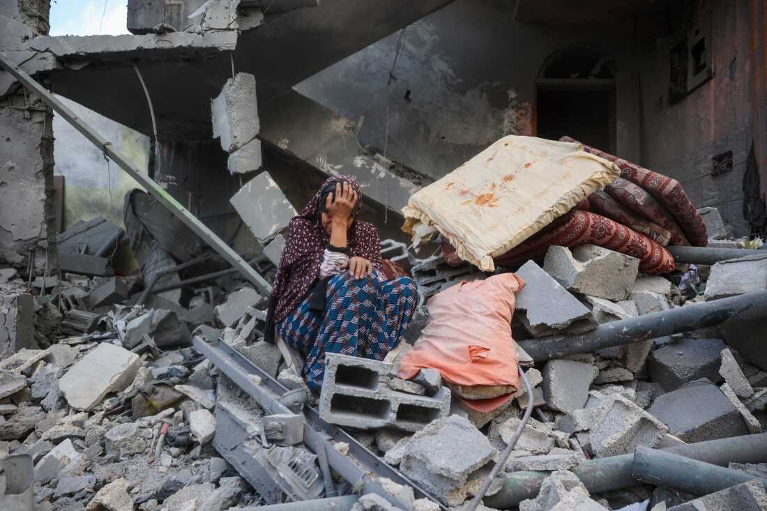 TOPSHOT - A woman cries while sitting on the rubble of her house, destroyed in an Israeli strike, in the Nuseirat refugee camp in central Gaza Strip on March 18, 2025. Israel on March 18 unleashed its most intense strikes on the Gaza Strip since a January ceasefire, with rescuers reporting 220 people killed, and Hamas accusing Benjamin Netanyahu of deciding to "resume war" after a deadlock on extending the truce. (Photo by Eyad BABA / AFP) (Photo by EYAD BABA/AFP via Getty Images)